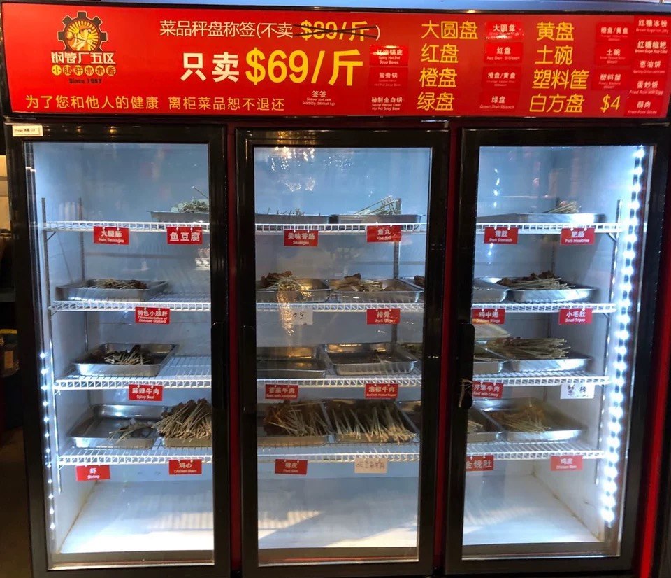 In-store ingredient display with labelled skewers and price signage